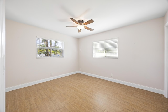 empty room with baseboards, light wood-style floors, and ceiling fan