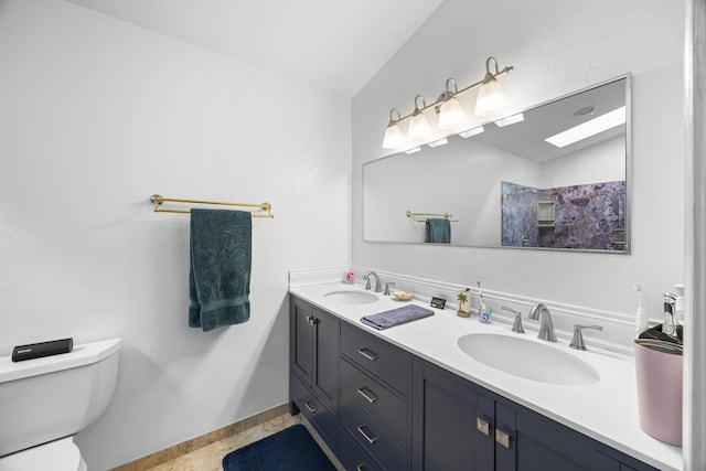 full bathroom with a sink, lofted ceiling, toilet, and double vanity