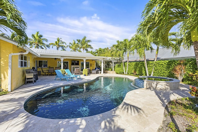 view of pool featuring a patio, ceiling fan, and a pool with connected hot tub