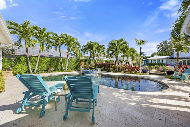 view of swimming pool with a patio area and a pool with connected hot tub