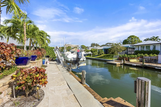 view of dock featuring boat lift and a water view