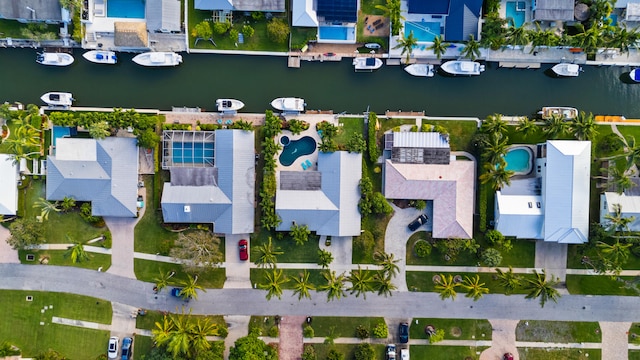 birds eye view of property with a water view and a residential view