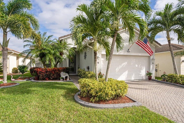 view of front of home with a garage and a front yard