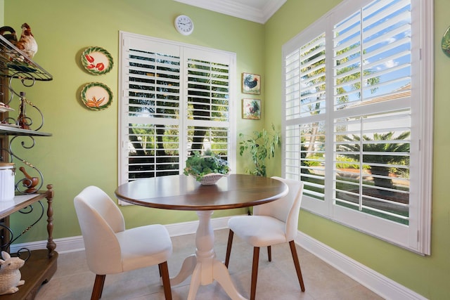 tiled dining space featuring ornamental molding