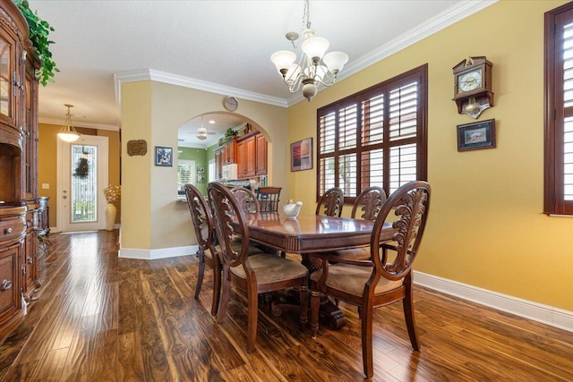 dining room with crown molding, dark hardwood / wood-style flooring, a healthy amount of sunlight, and ceiling fan with notable chandelier