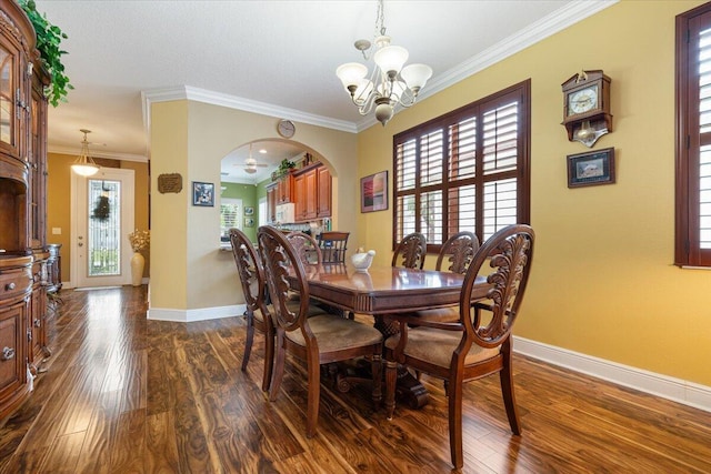 225 SW Coconut Key Way, Port Saint Lucie, FL 34986 - dining area featuring dark wood-type flooring, a chandelier, baseboards, arched walkways, and crown molding