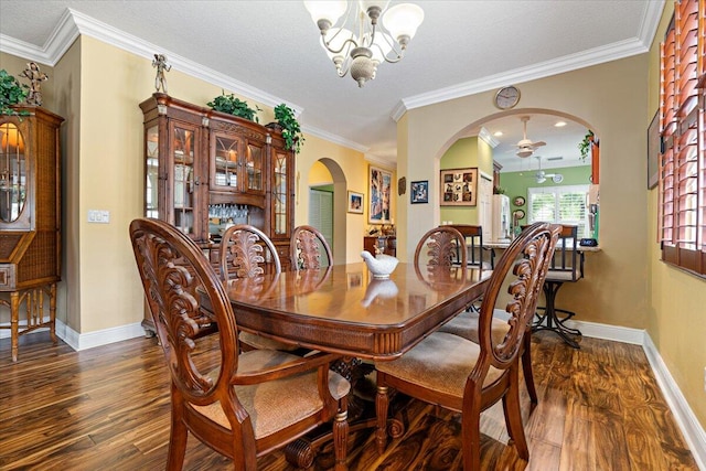 dining room featuring ceiling fan with notable chandelier, dark hardwood / wood-style flooring, ornamental molding, and a textured ceiling