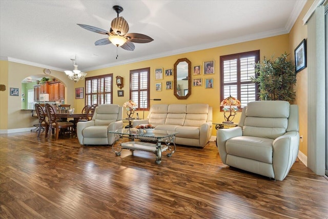 living room with ceiling fan with notable chandelier, dark hardwood / wood-style floors, and ornamental molding