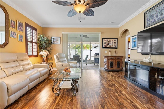 living room featuring ceiling fan, wood-type flooring, and ornamental molding