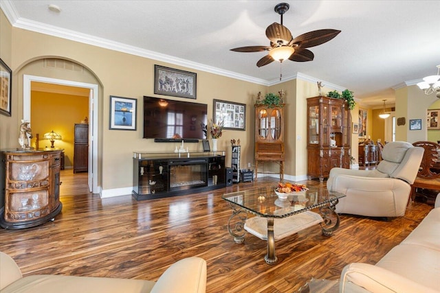 living room featuring ceiling fan with notable chandelier, wood-type flooring, ornamental molding, and a textured ceiling