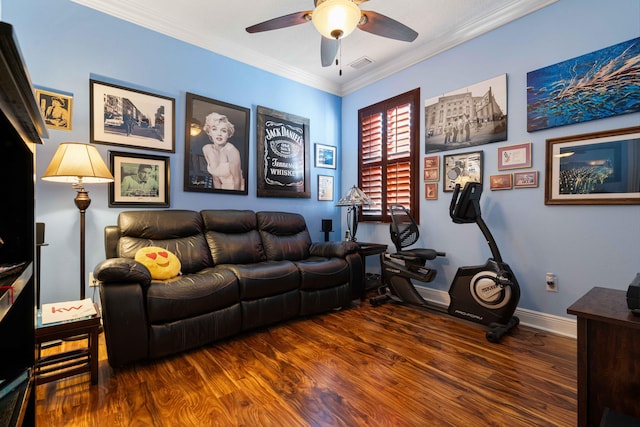 living room with crown molding, ceiling fan, and dark wood-type flooring