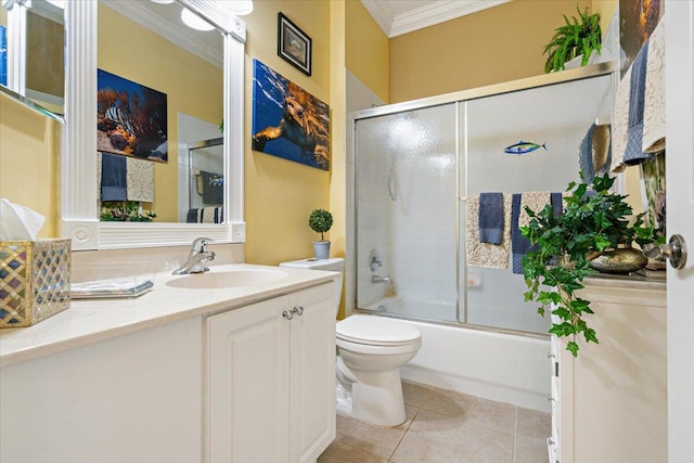 full bathroom featuring tile patterned flooring, combined bath / shower with glass door, crown molding, toilet, and vanity