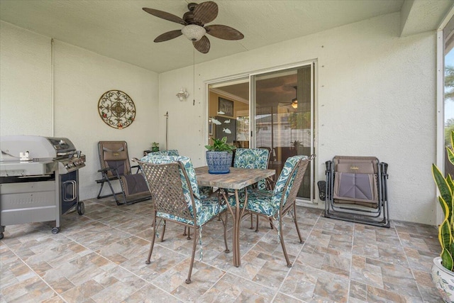 view of patio with a grill and ceiling fan