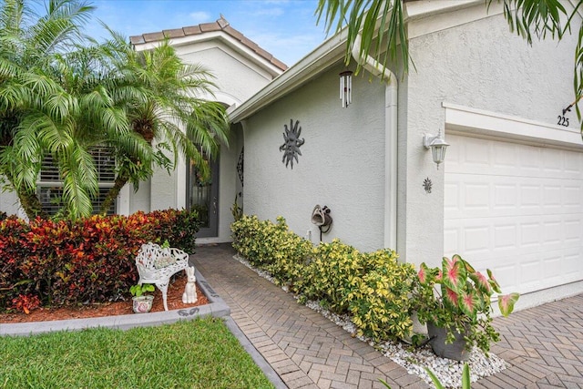 view of exterior entry featuring a garage