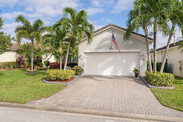 view of front of house with a front yard and a garage