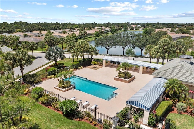 view of pool featuring a patio and a water view