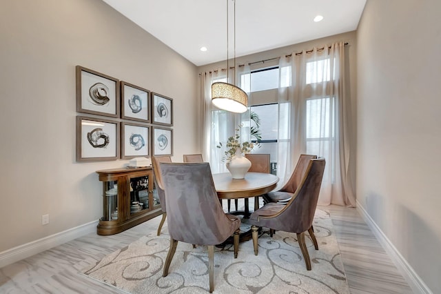 dining area with light wood finished floors, baseboards, and recessed lighting