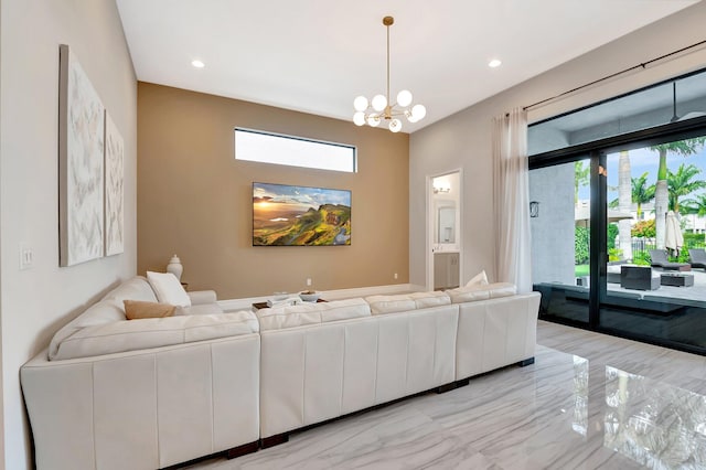 living room featuring marble finish floor, recessed lighting, a wealth of natural light, and an inviting chandelier