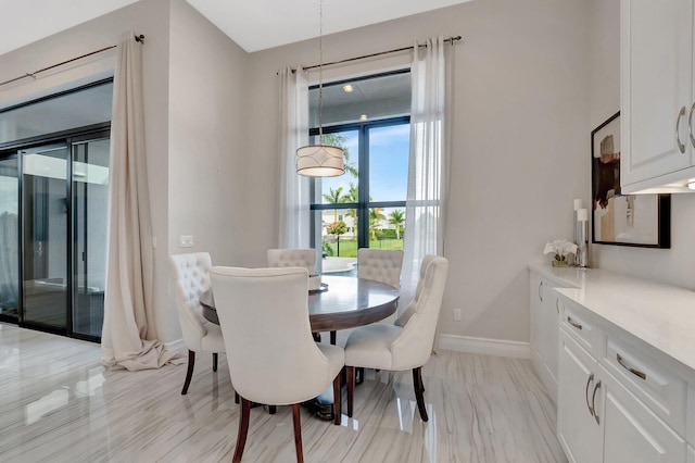 dining space featuring baseboards