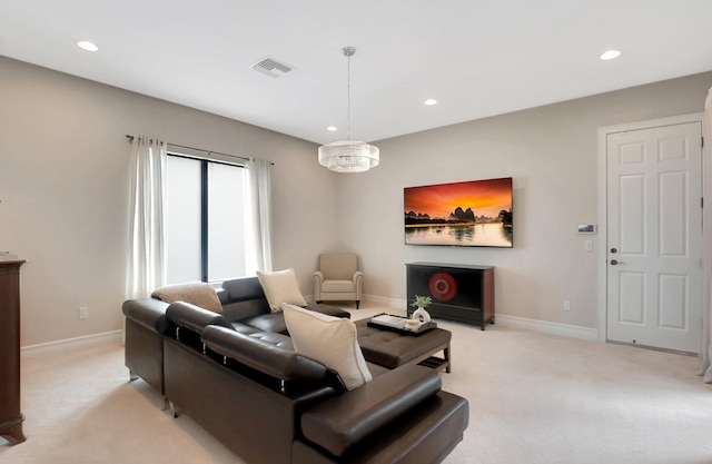 living room with baseboards, recessed lighting, visible vents, and light colored carpet