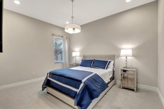 bedroom with baseboards, recessed lighting, and light colored carpet