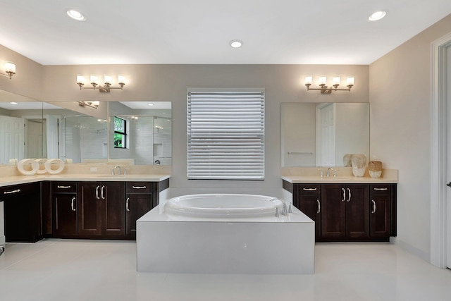 full bath featuring recessed lighting, two vanities, a stall shower, a sink, and a bath