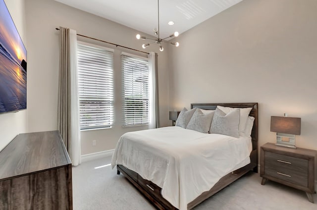 bedroom with baseboards, a notable chandelier, and light colored carpet