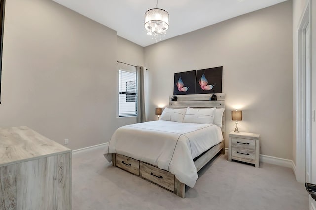 bedroom featuring light carpet, baseboards, and a chandelier