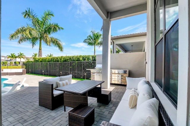 view of patio with area for grilling, fence, and an outdoor living space