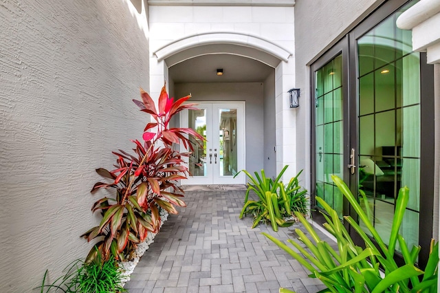 doorway to property with french doors and stucco siding