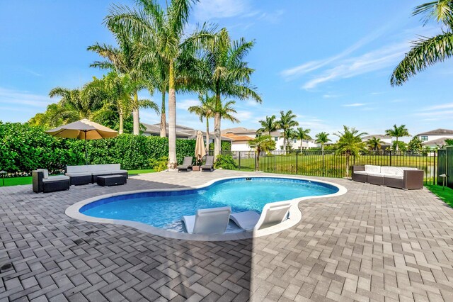 view of swimming pool featuring a patio, a fenced backyard, and an outdoor living space