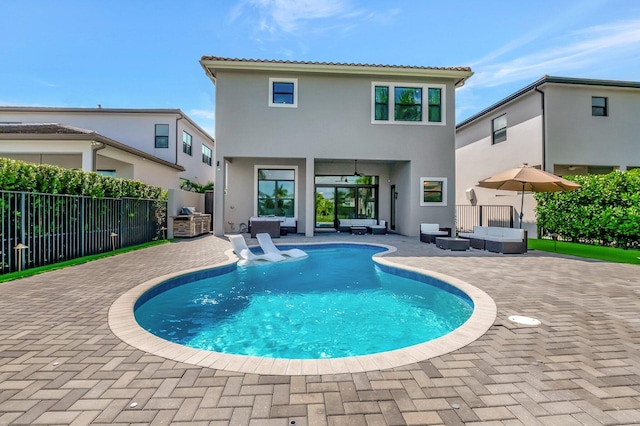 rear view of house with a patio, fence, an outdoor living space, and stucco siding