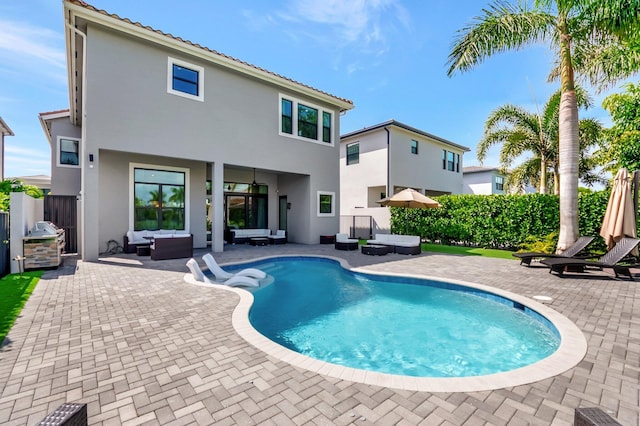 view of pool with a patio area, fence, an outdoor living space, and a fenced in pool