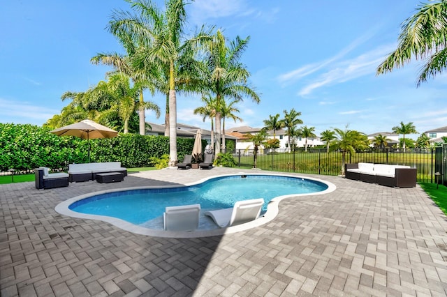 view of pool featuring a patio, fence, an outdoor living space, and a fenced in pool