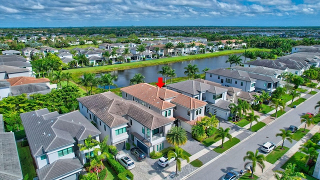 birds eye view of property featuring a water view and a residential view