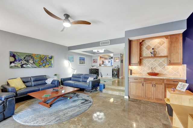 living room featuring marble finish floor, visible vents, and ceiling fan