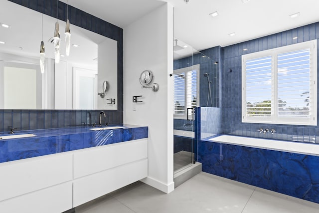 bathroom with tile patterned flooring, vanity, and independent shower and bath