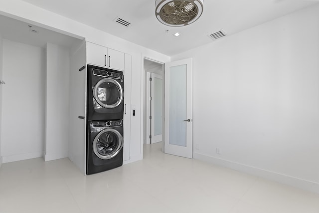 laundry room with stacked washer and dryer