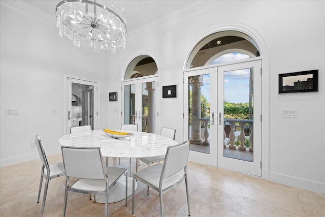 dining space with french doors, an inviting chandelier, and ornamental molding