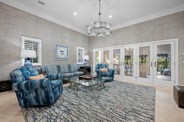 living room featuring crown molding, french doors, and a chandelier