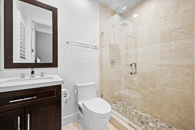 bathroom with vanity, toilet, and a shower with door