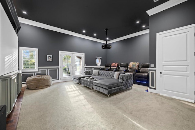 cinema room featuring carpet flooring, french doors, and ornamental molding