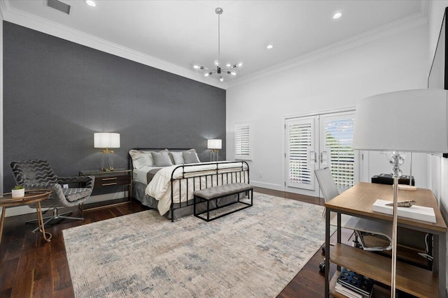 bedroom featuring a chandelier, french doors, dark hardwood / wood-style flooring, and crown molding