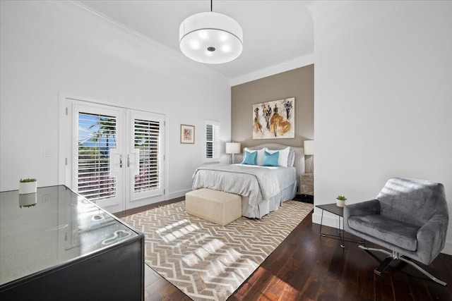 bedroom with dark hardwood / wood-style flooring, ornamental molding, access to outside, and french doors