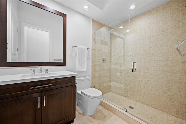 bathroom with vanity, a shower with shower door, and toilet