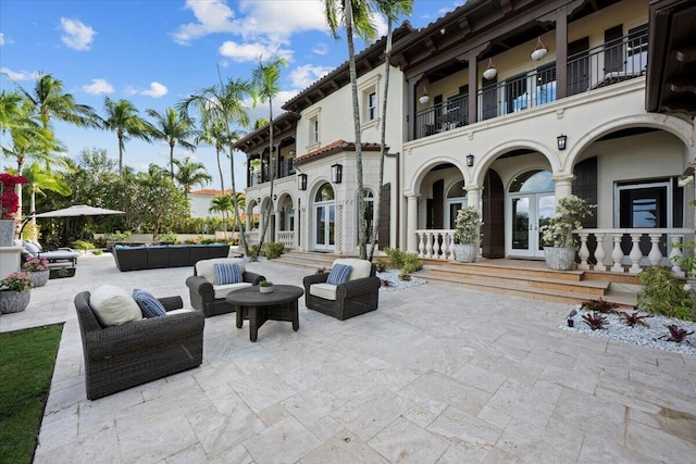 view of patio / terrace featuring french doors, a balcony, and an outdoor hangout area