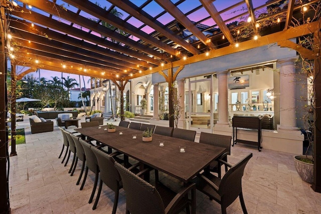 patio terrace at dusk with a pergola and an outdoor hangout area