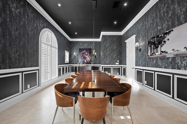 dining space with ornamental molding