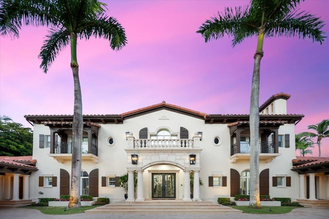 view of front facade with french doors and a balcony