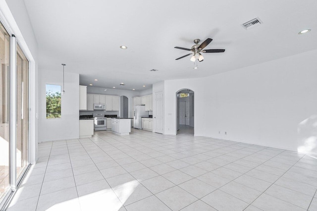 unfurnished living room with ceiling fan and light tile patterned floors